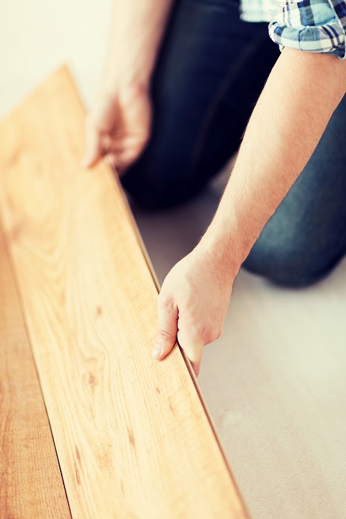 male-hands-intalling-wood-flooring installation